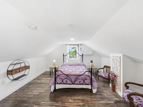 a bedroom with furniture and a wooden floor