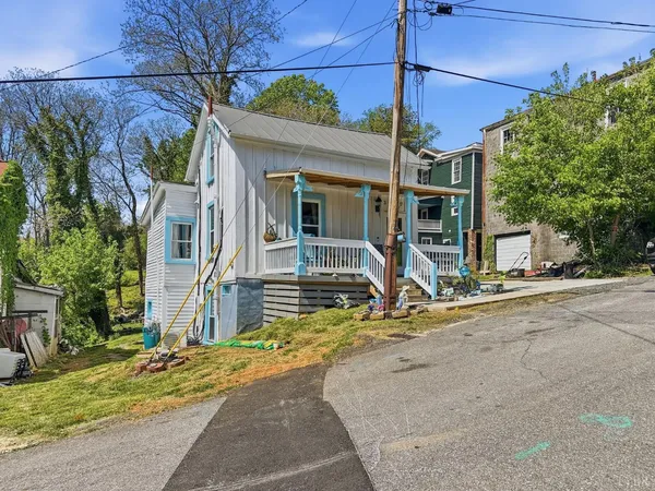 a view of a house with a patio and a yard
