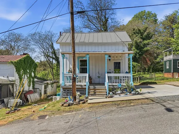 a view of a house with a patio and a yard