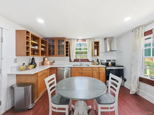 a kitchen with a table chairs refrigerator and cabinets