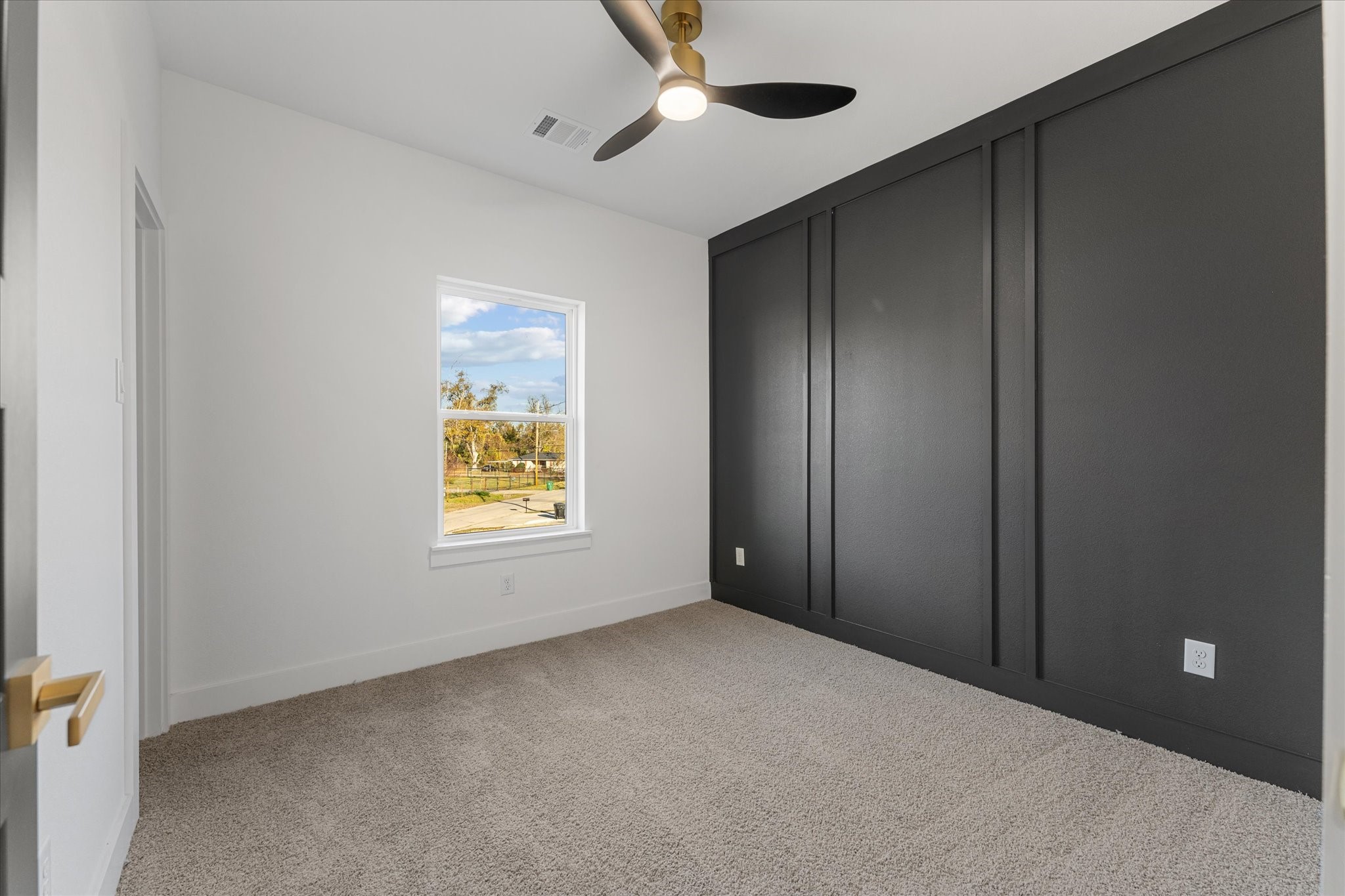 1010 Calvin Street Houston, TX 77088 - Photo 18 of 20 Primary bedroom with custom accent wall.Photos are from builders previously built model, same floor plan and finishes.