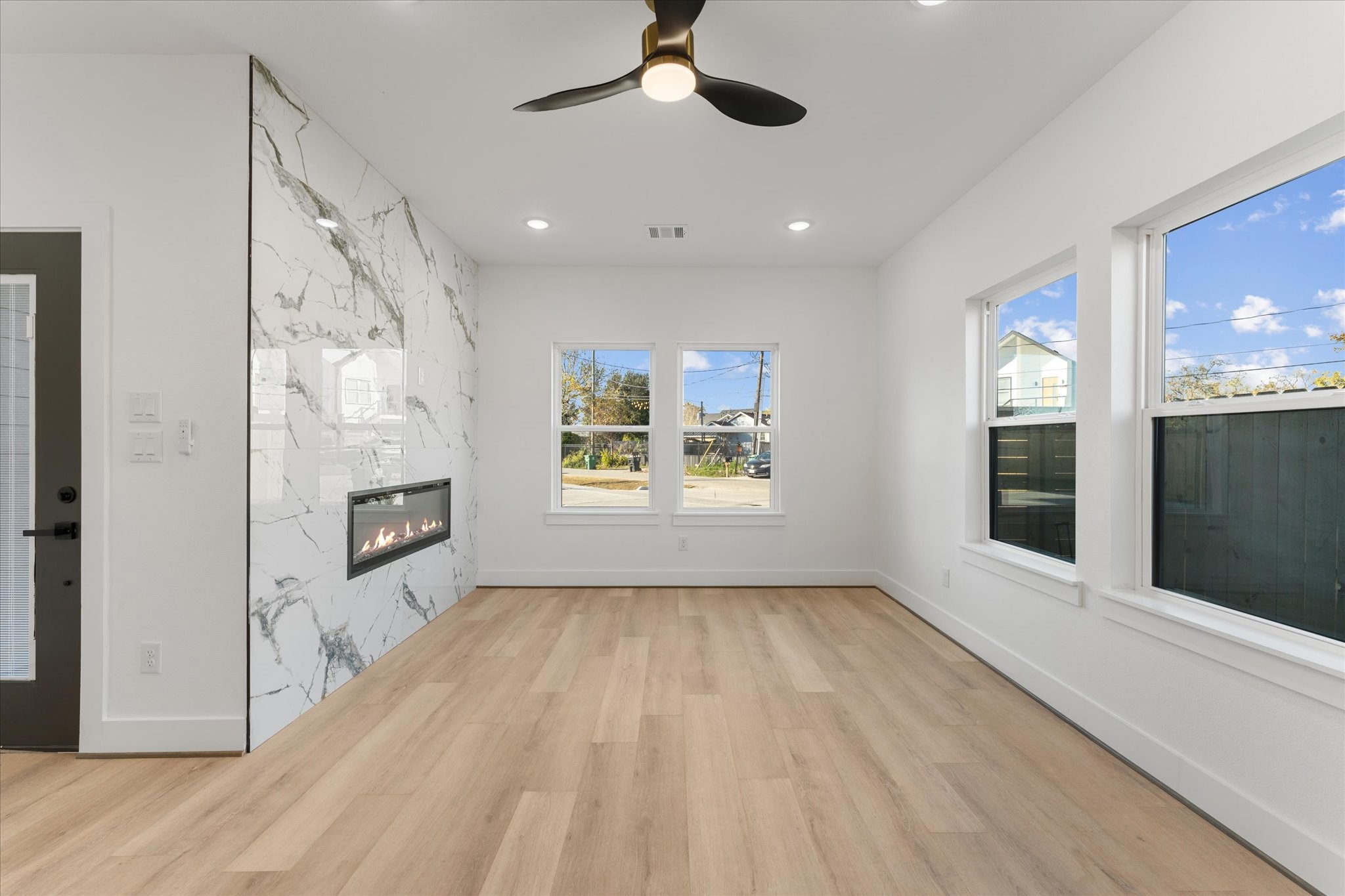 1010 Calvin Street Houston, TX 77088 - Photo 4 of 20 This bright living space features a sleek, modern design with an accent wall and a built in fireplace. Windows provide plenty of natural light. Photos are from builders previously built model with same lay out and finishes.