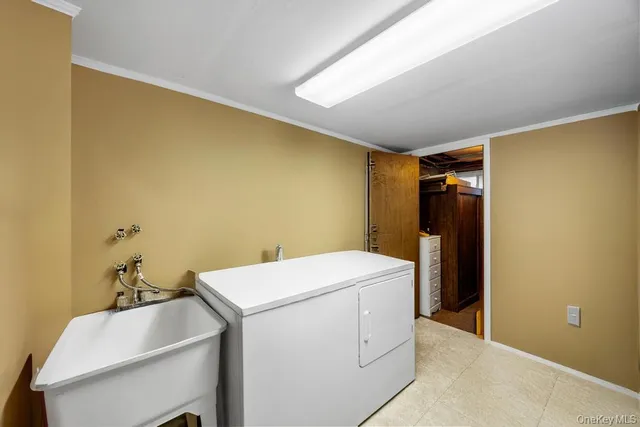 a utility room with wooden floor washer and dryer