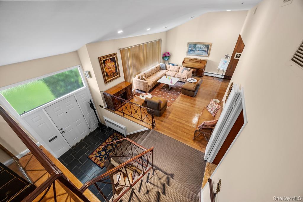 797 Caldwell Avenue Valley Stream, NY 11581 - Photo 39 of 45 Living room with lofted ceiling, recessed lighting, wood finished floors, and baseboard heating