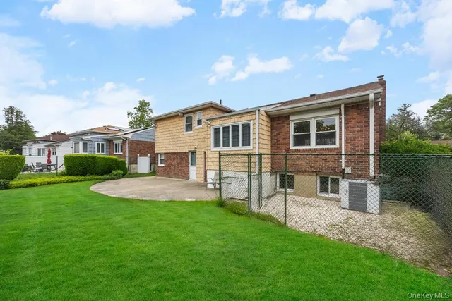 a view of a house with a yard and sitting area