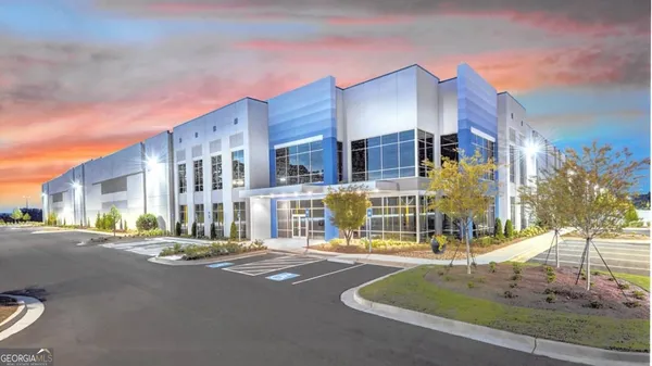 an aerial view of a house with a yard and a large pool