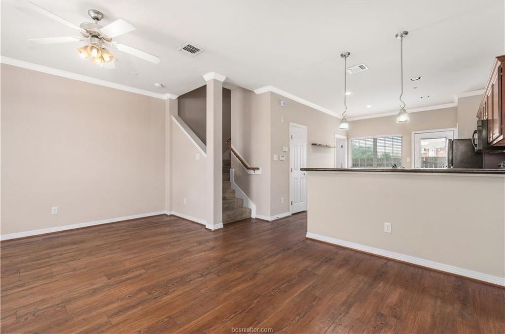 1198 Jones-Butler Road, Unit 602 College Station, TX 77840 - Photo 2 of 10 a view of a kitchen with a refrigerator a window and wooden floor