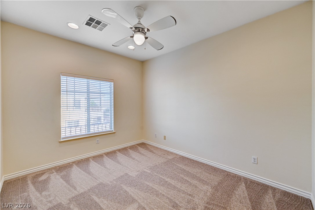 6761 Clay TABLET Street Las Vegas, NV 89149 - Photo 59 of 73 Plush carpeting and a wide window with blinds define this versatile secondary bedroom space.