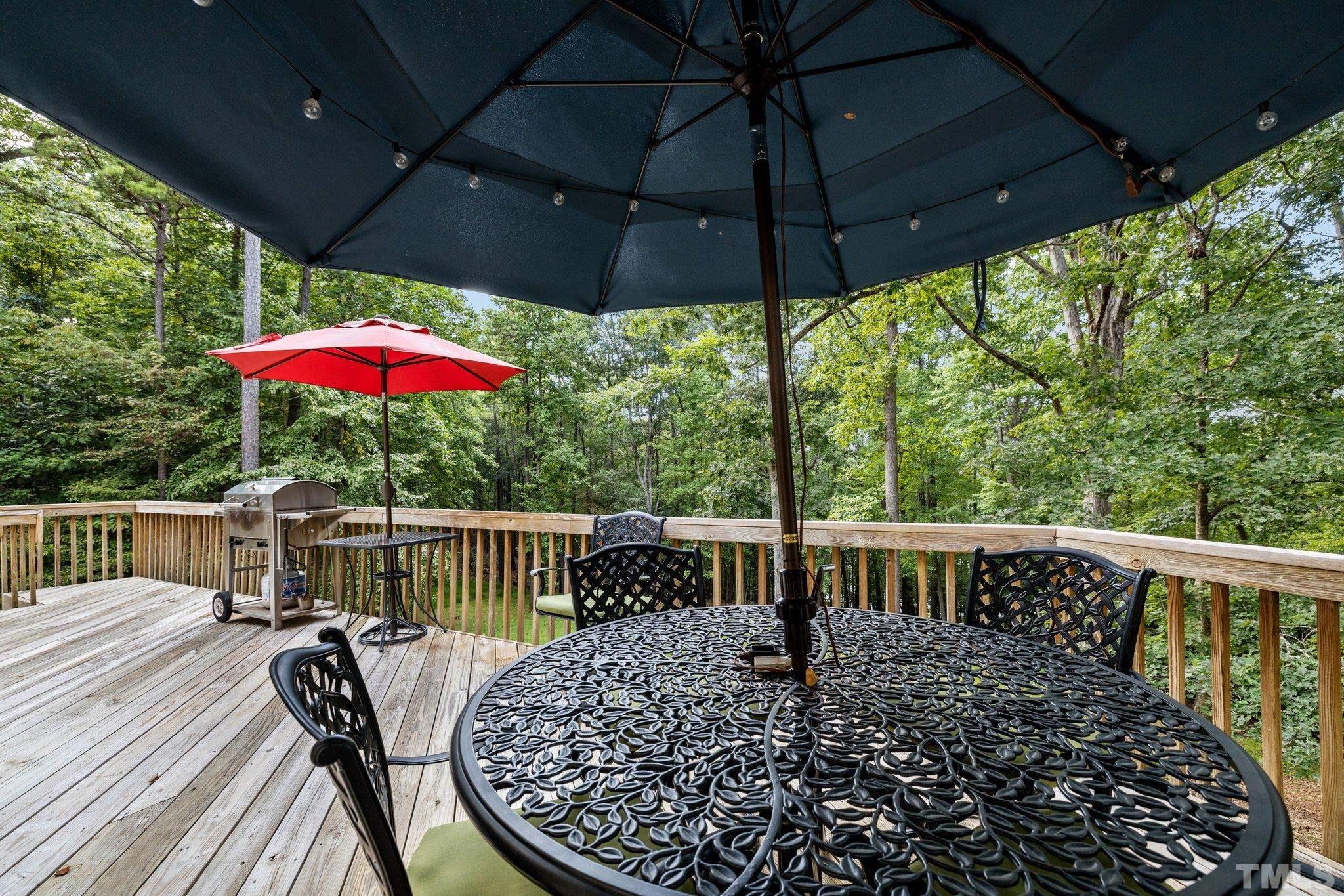 1304 Adams Mountain Road Raleigh, NC 27614 - Photo 54 of 69 a view of balcony with furniture and umbrella