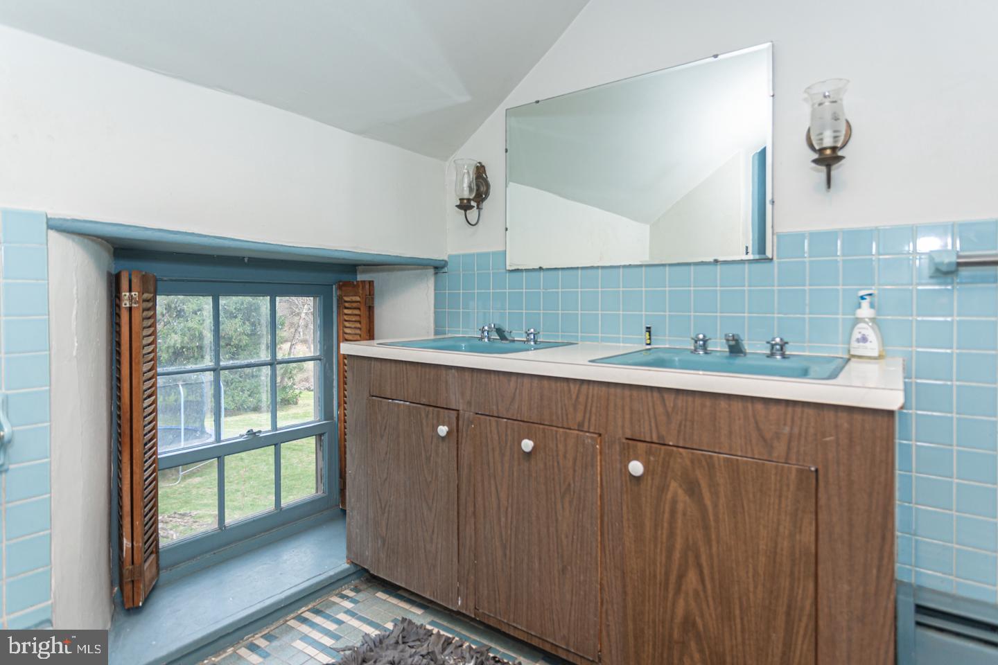 2 Woodhill Road Newtown, PA 18940 - Photo 23 of 58 a bathroom with a sink mirror and a shower