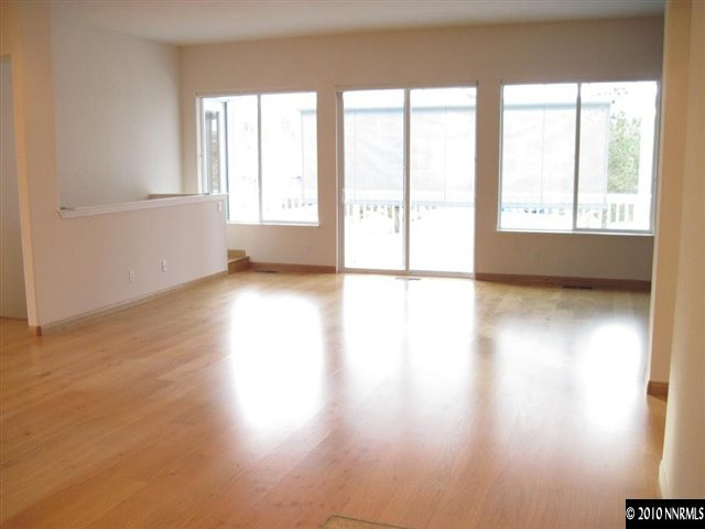 1697 Aspen Creek Road Reno, NV 89519 - Photo 4 of 9 a view of an empty room with wooden floor and a window