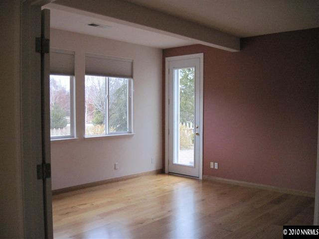 1697 Aspen Creek Road Reno, NV 89519 - Photo 6 of 9 an empty room with wooden floor and windows