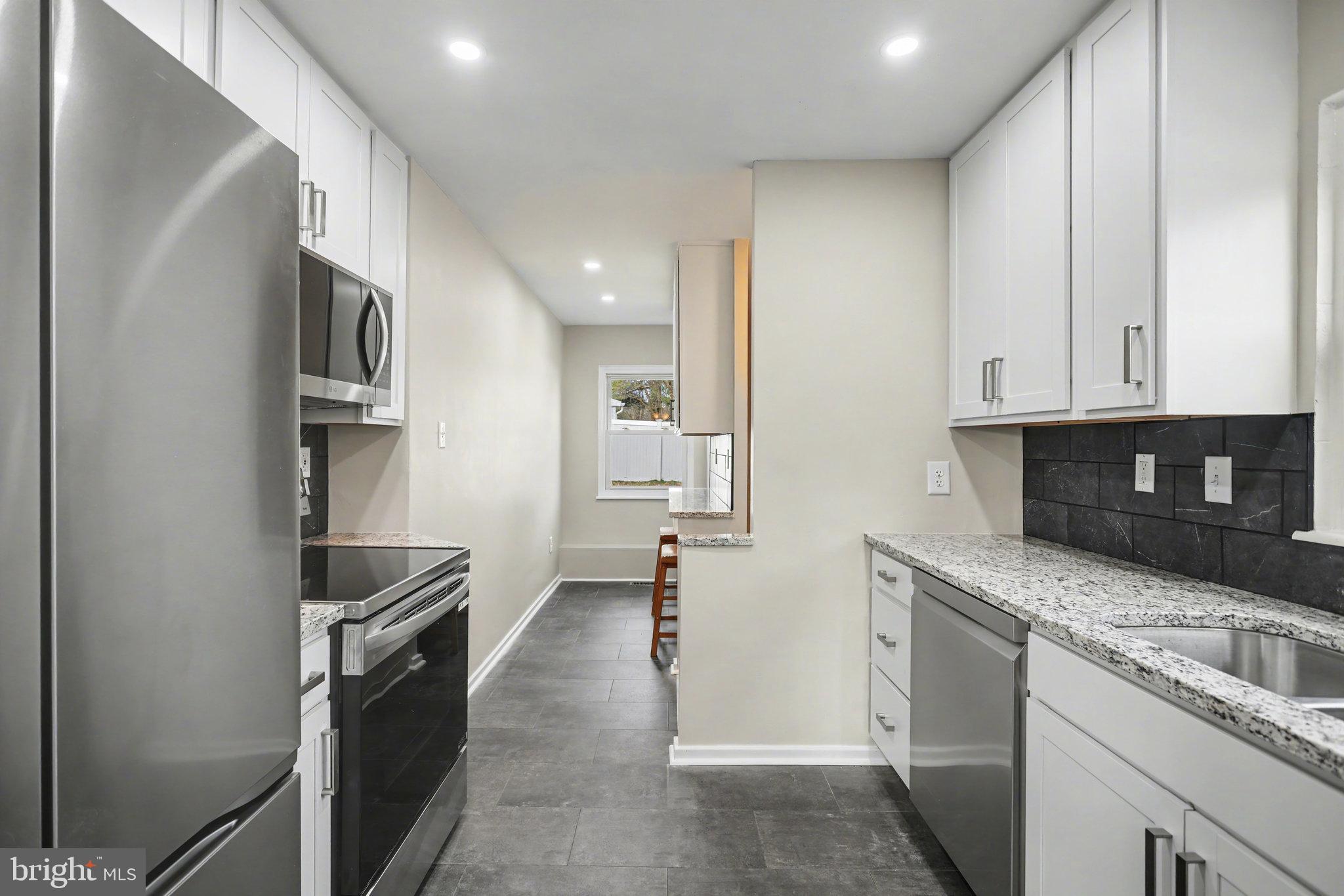 1402 Warwick Road Camp Hill, PA 17011 - Photo 11 of 36 a kitchen with stainless steel appliances granite countertop a stove and a refrigerator