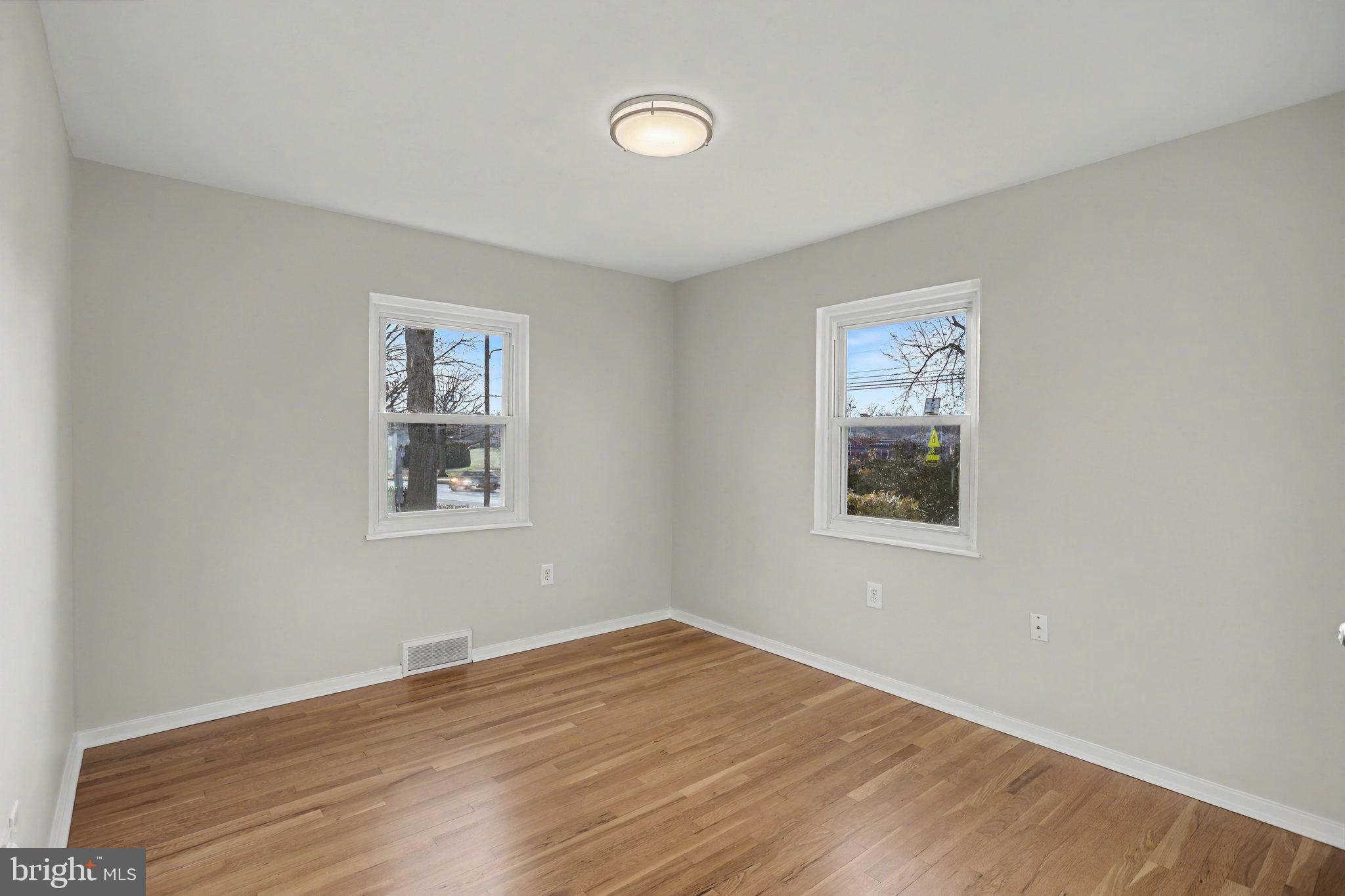 1402 Warwick Road Camp Hill, PA 17011 - Photo 16 of 36 a view of an empty room with wooden floor and a window