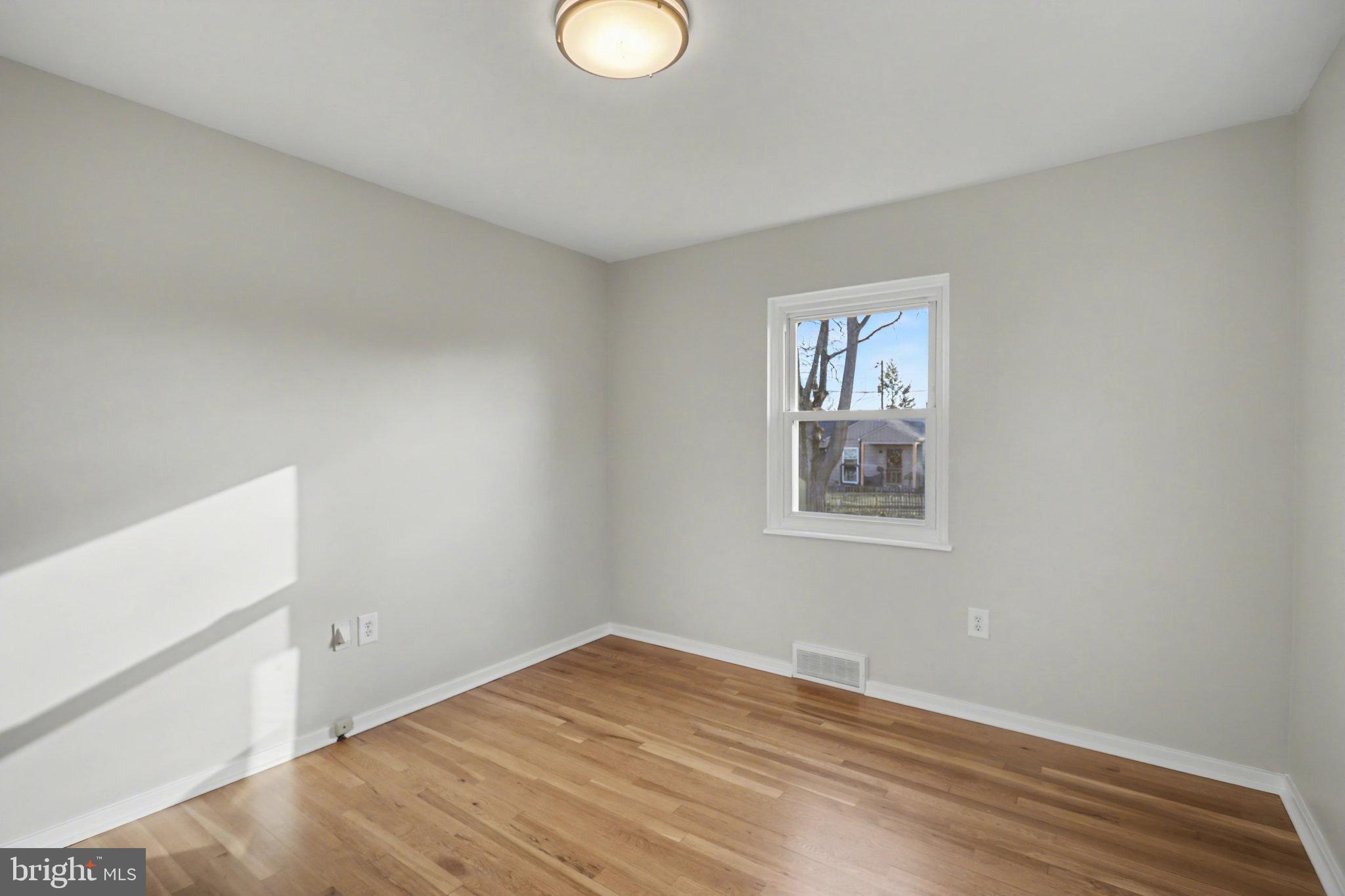 1402 Warwick Road Camp Hill, PA 17011 - Photo 18 of 36 a view of a room that has a window and wooden floor
