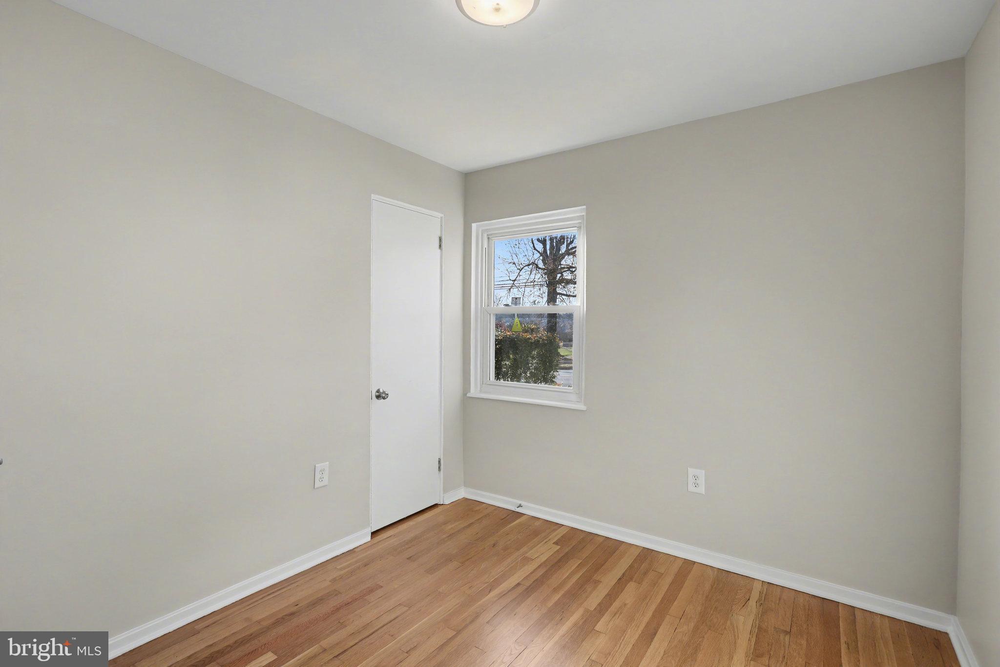1402 Warwick Road Camp Hill, PA 17011 - Photo 21 of 36 a view of an empty room with wooden floor and a window
