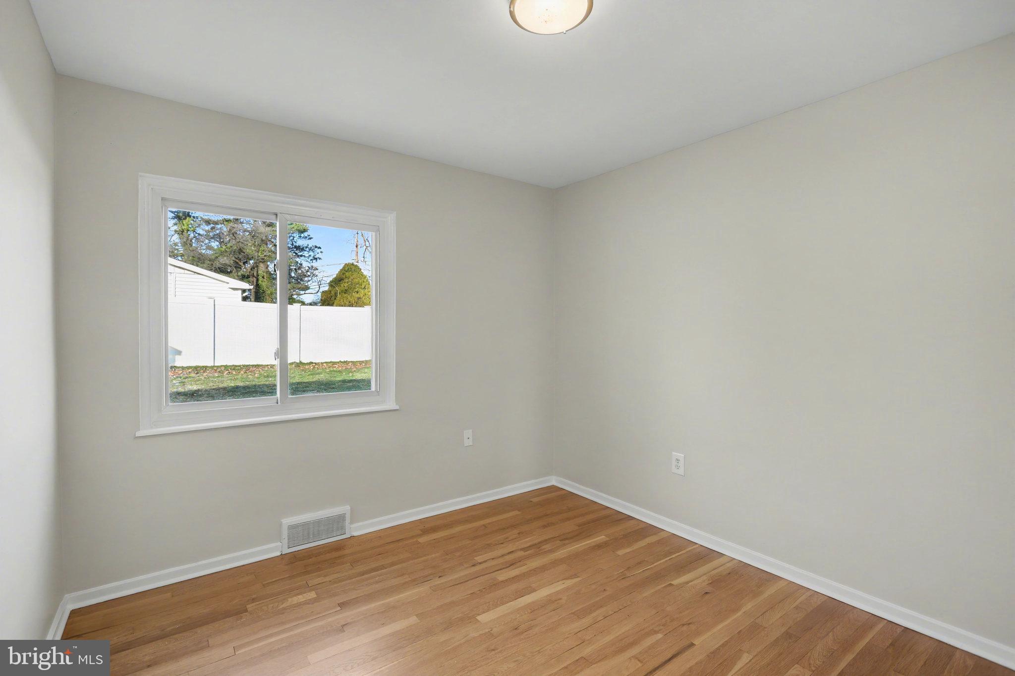 1402 Warwick Road Camp Hill, PA 17011 - Photo 23 of 36 a view of an empty room with wooden floor and a window