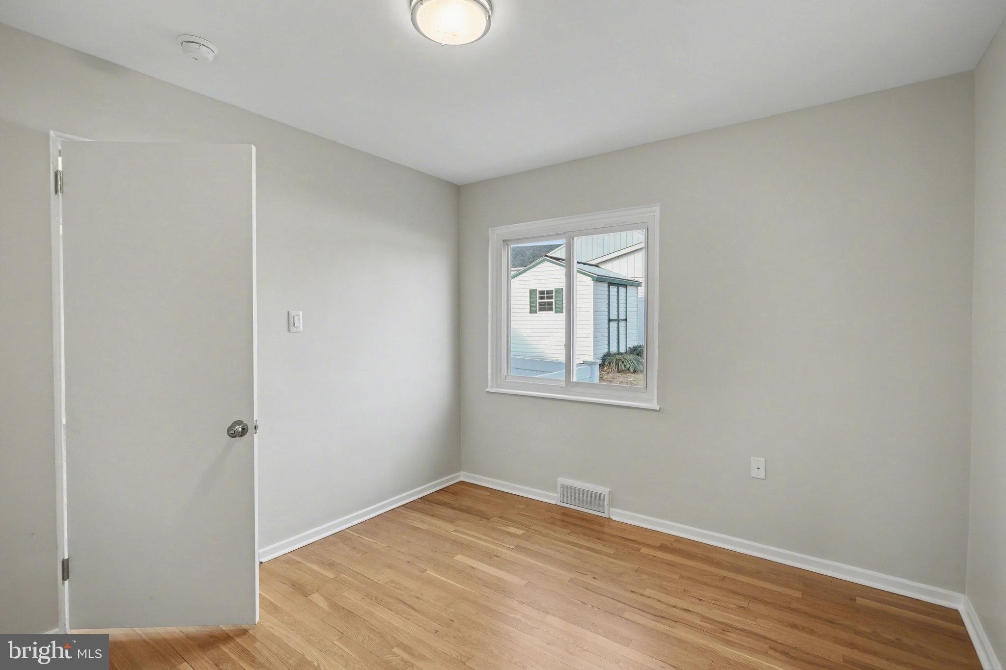 1402 Warwick Road Camp Hill, PA 17011 - Photo 25 of 36 an empty room with wooden floor and windows