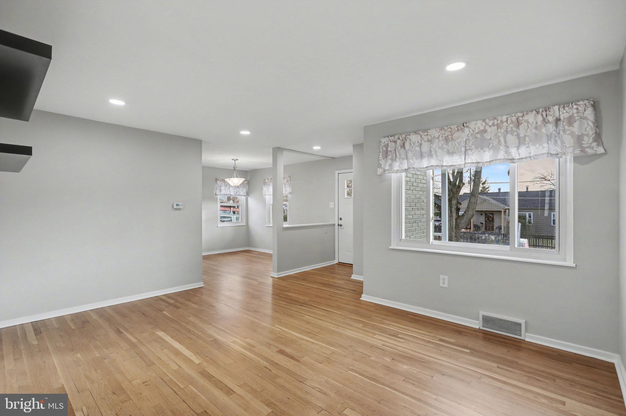 1402 Warwick Road Camp Hill, PA 17011 - Photo 6 of 36 a view of an empty room with wooden floor and a window