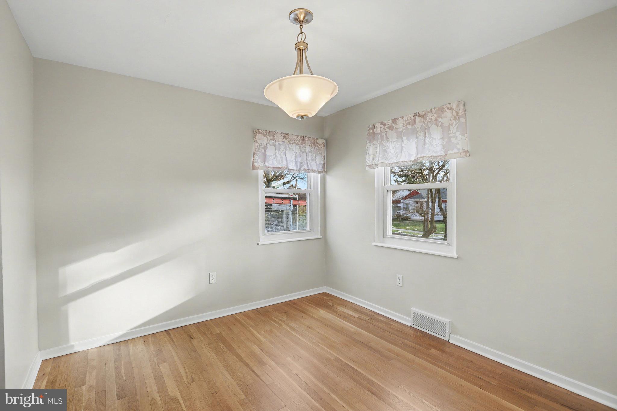 1402 Warwick Road Camp Hill, PA 17011 - Photo 8 of 36 a view of empty room with wooden floor and fan