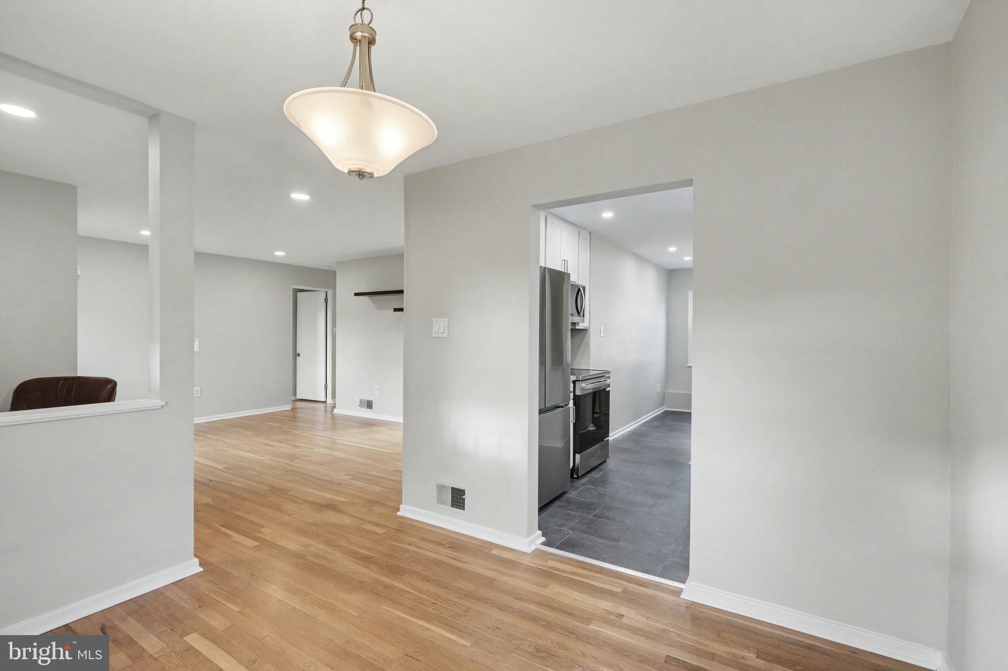 1402 Warwick Road Camp Hill, PA 17011 - Photo 10 of 36 a view of a hallway with wooden floor cabinets and a kitchen