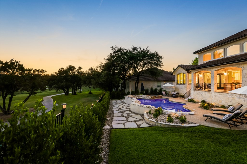 14901 Spillman Ranch Loop Austin, TX 78738 - Photo 1 of 1 a view of a house with backyard sitting area and garden