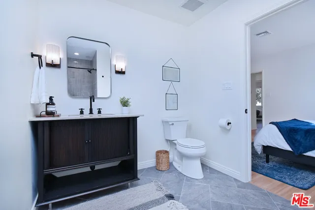 a bathroom with a sink toilet and a mirror
