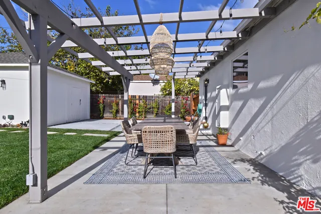 a view of a porch with furniture and a garden