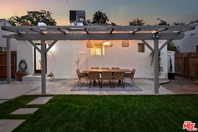 a view of a porch with a table and chairs