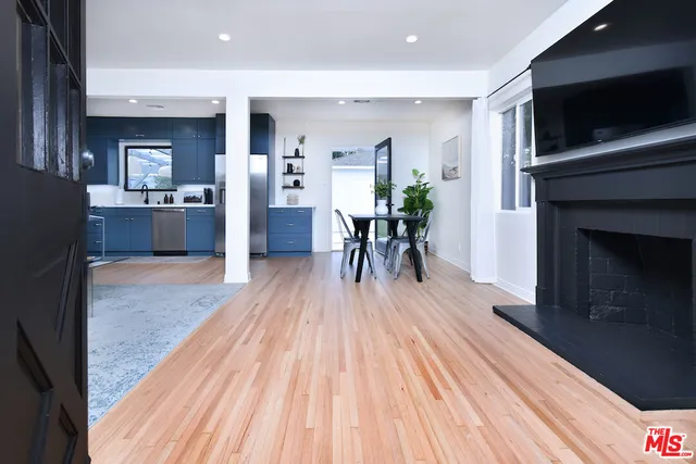 a view of kitchen with sink and refrigerator