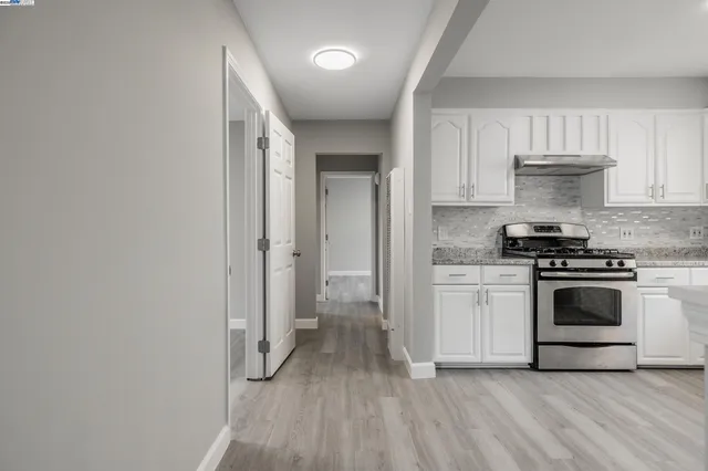 a kitchen with a refrigerator and a stove