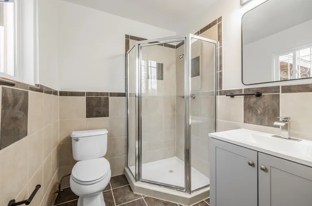 a bathroom with a shower a toilet and a sink