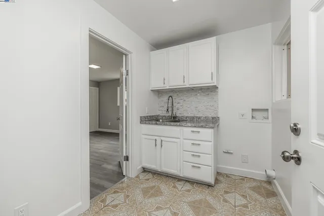 a room with a cabinets and a washing machine