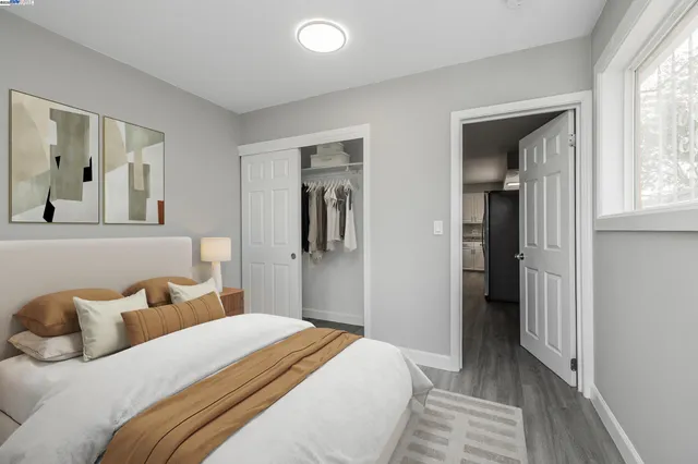 a bedroom with a bed and a mirror