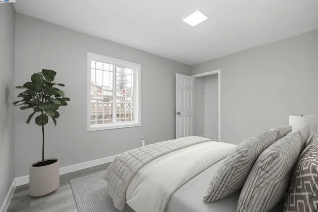 a bedroom with a bed and a potted plant