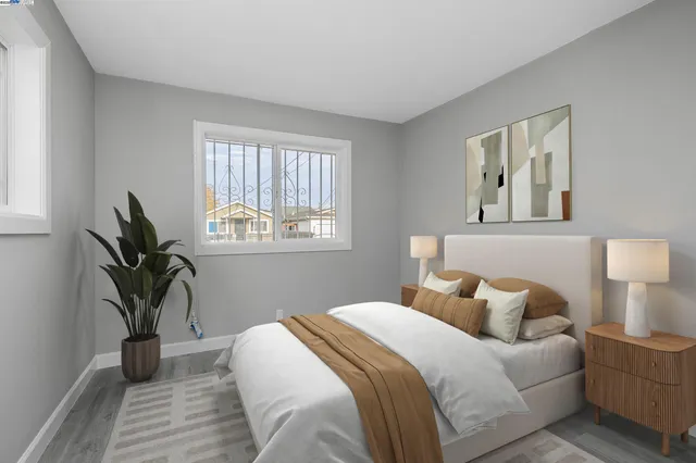 a bedroom with a bed and a potted plant