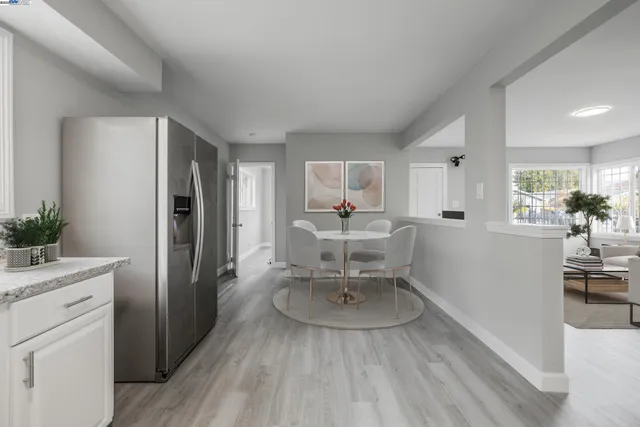 a living room with furniture and a dining table with kitchen view
