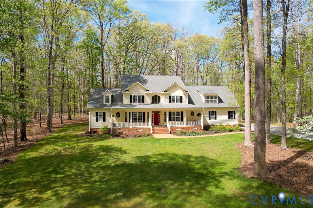 a view of a house with a yard and sitting area