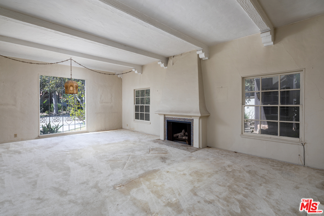 520 North Camden Drive Beverly Hills, CA 90210 - Photo 3 of 6 an empty room with windows and fireplace