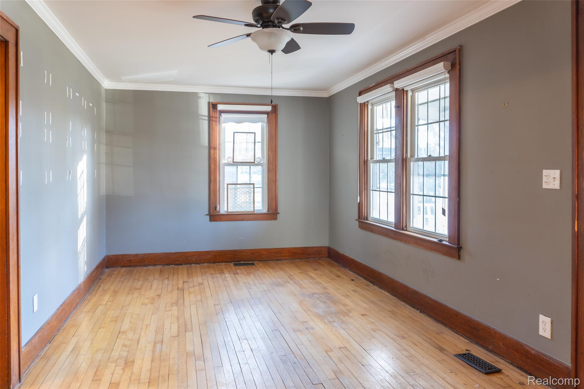 1846 North Gulley Road Dearborn, MI 48128 - Photo 2 of 32 Unfurnished room featuring ornamental molding, light wood finished floors, and ceiling fan