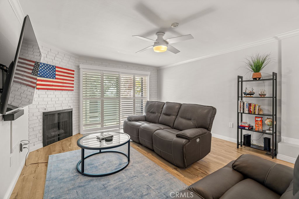 1321 Beryl Street, Unit 101 Redondo Beach, CA 90277 - Photo 14 of 40 a living room with furniture a fireplace and a flat screen tv