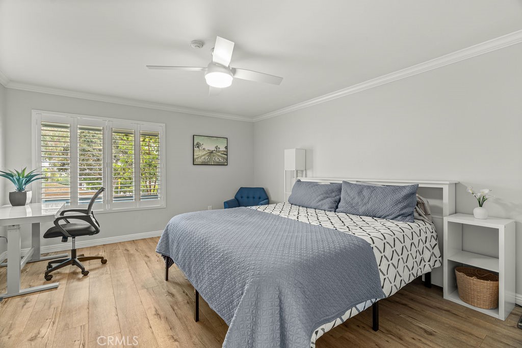 1321 Beryl Street, Unit 101 Redondo Beach, CA 90277 - Photo 24 of 40 a bedroom with a bed a table and a chandelier