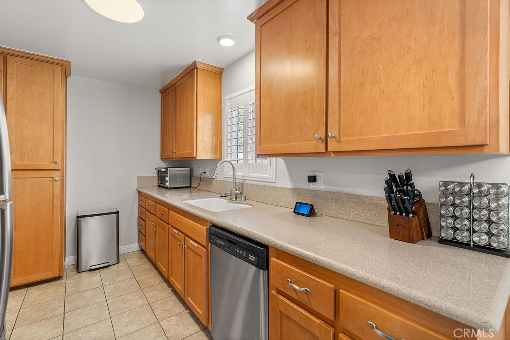 1321 Beryl Street, Unit 101 Redondo Beach, CA 90277 - Photo 10 of 40 a kitchen with stainless steel appliances a sink dishwasher refrigerator and cabinets