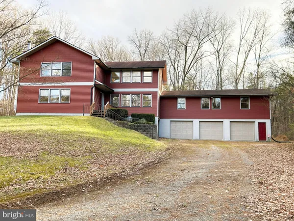 a view of a house with a yard and garage