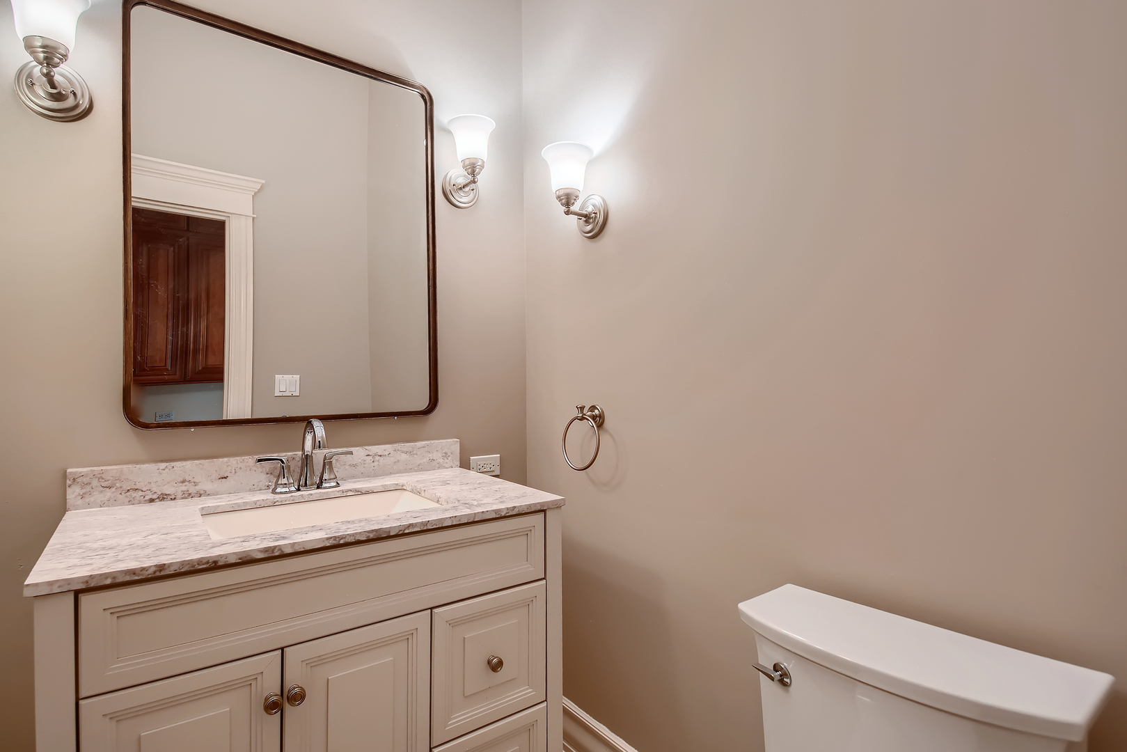 1011 Willow Road Winnetka, IL 60093 - Photo 14 of 37 a bathroom with a granite countertop toilet sink and mirror