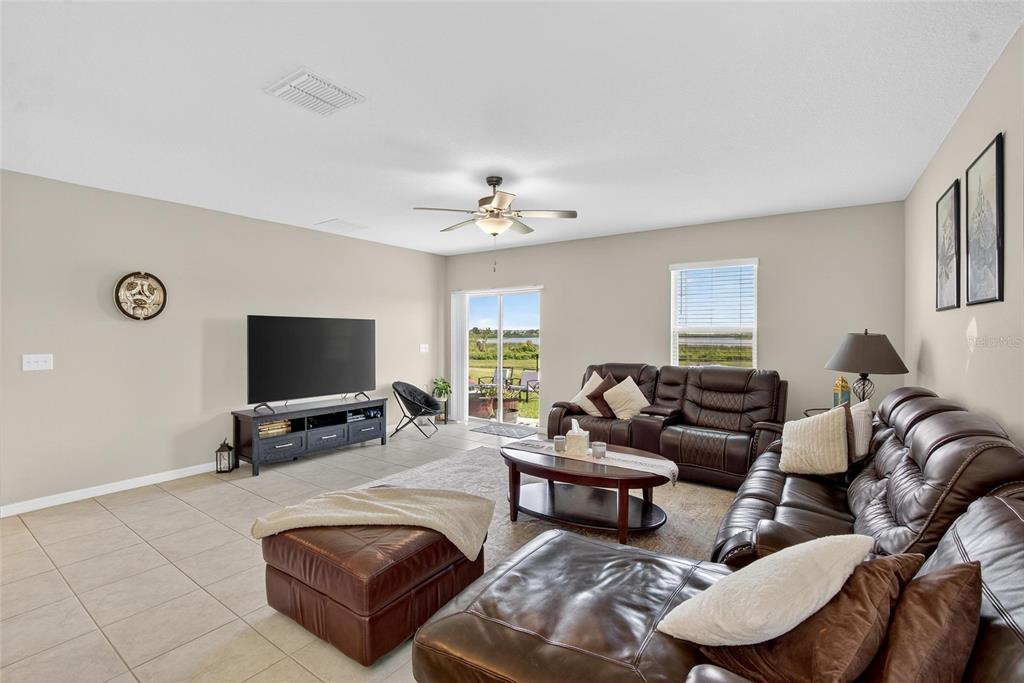 31783 Sun Kettle Loop Wesley Chapel, FL 33545 - Photo 16 of 73 a living room with furniture and a flat screen tv