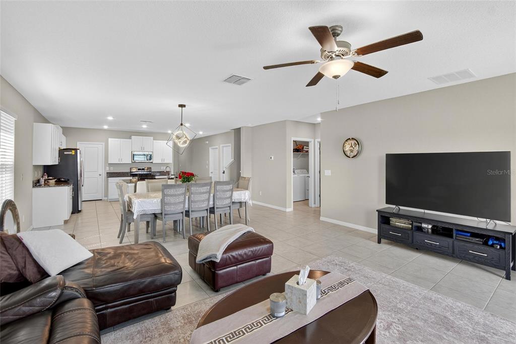 31783 Sun Kettle Loop Wesley Chapel, FL 33545 - Photo 18 of 73 a living room with furniture and a flat screen tv
