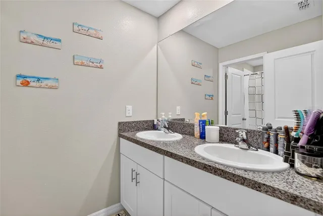 a view of a big house with a big yard and large trees