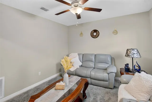 a living room with furniture a rug and a window