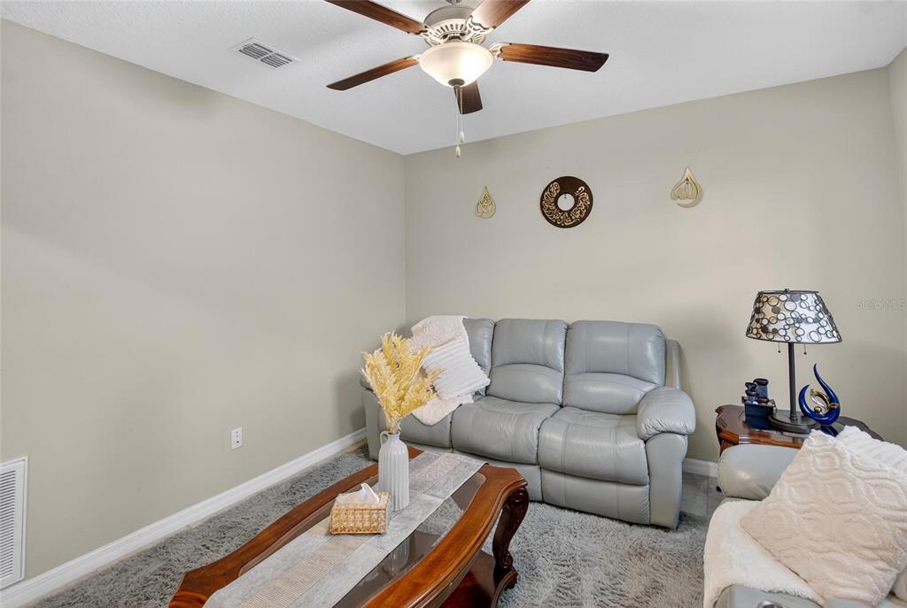 31783 Sun Kettle Loop Wesley Chapel, FL 33545 - Photo 4 of 73 a living room with furniture and a window
